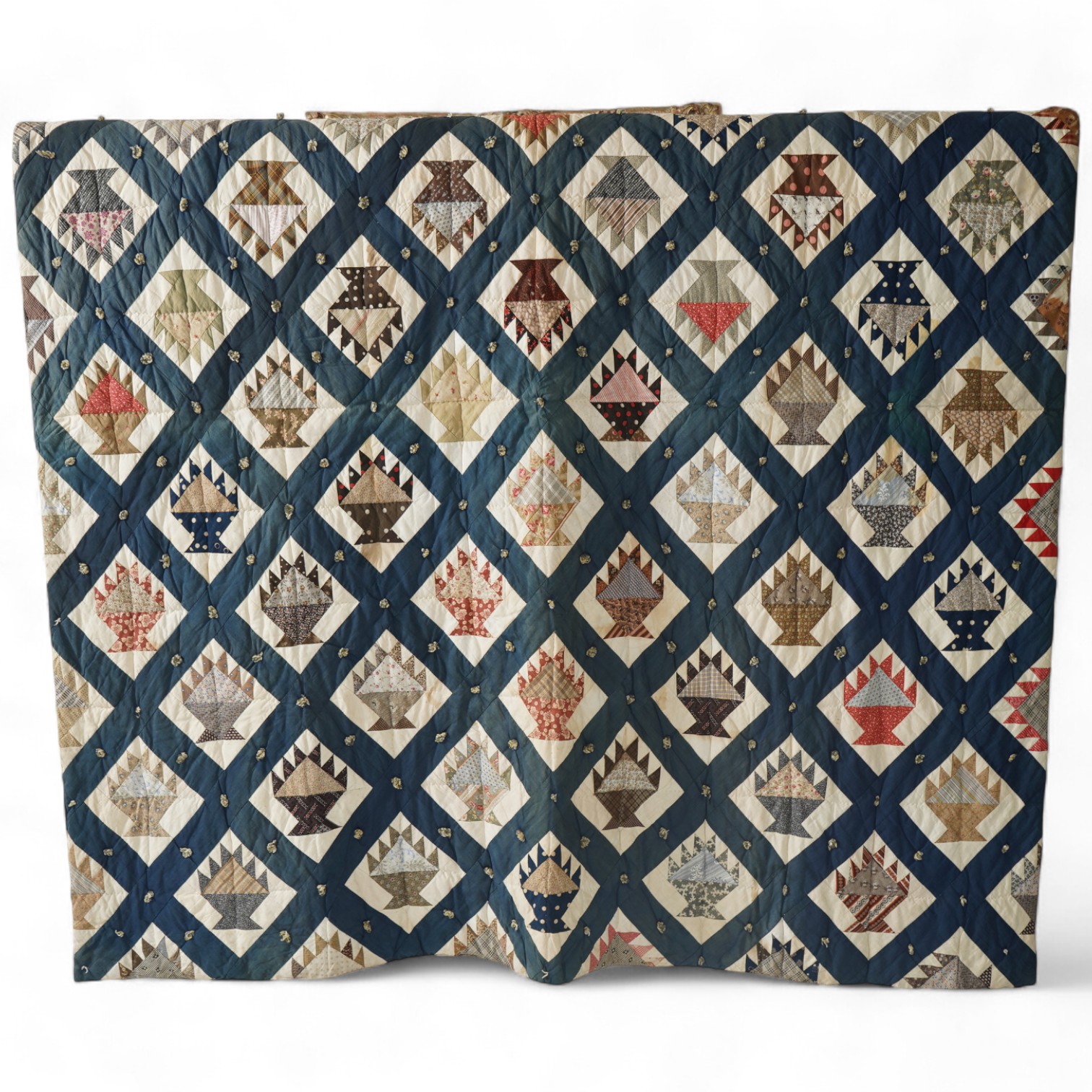 A bold handsome, American, Vermont 1865 (Civil War) ‘basket’ and lattice, hand quilted and piece tied bedcover, with an ornate floral backing. Worked with a plain navy cotton lattice border around central stylised printe